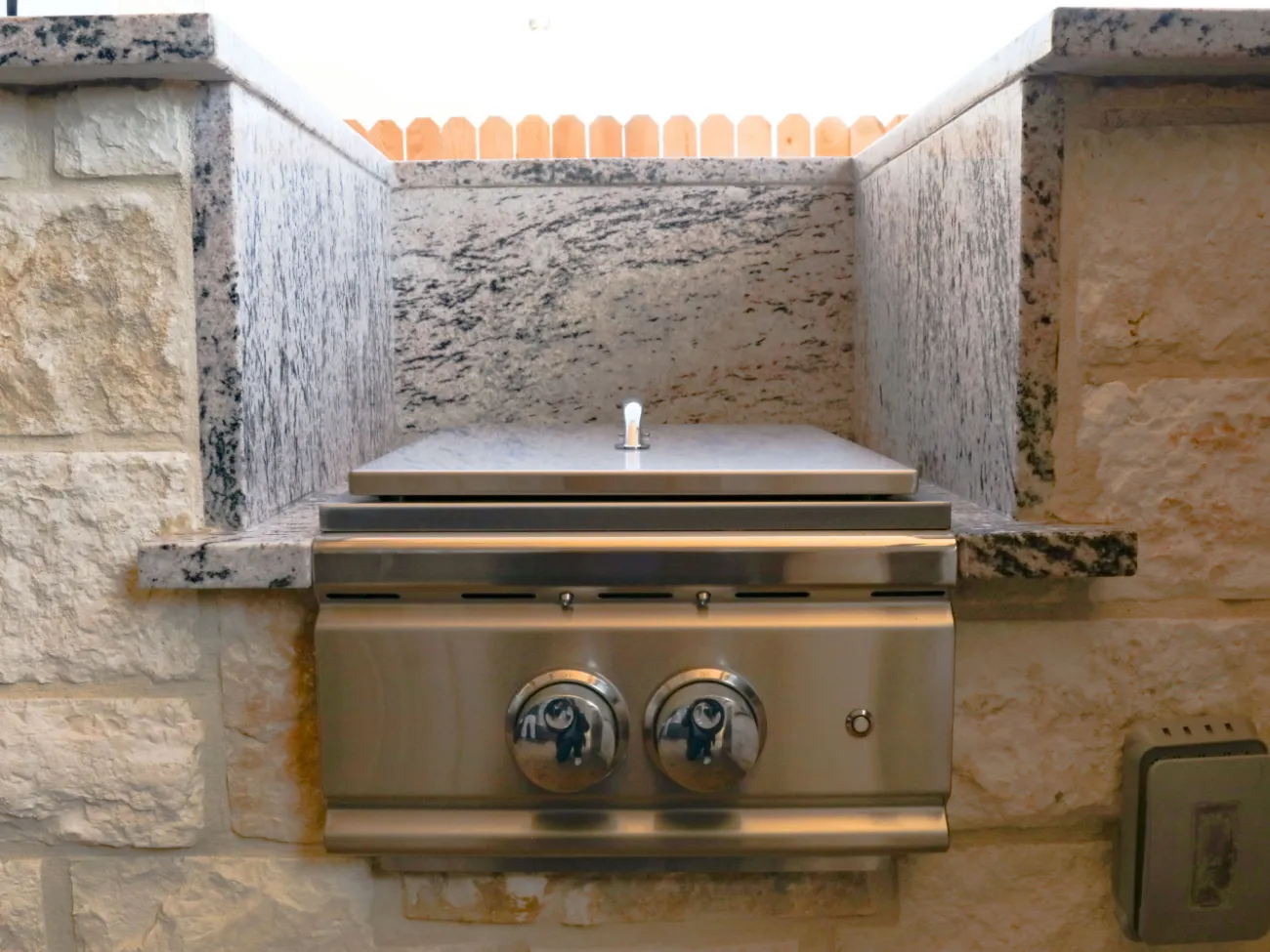 custom side burner adjacent to an outdoor kitchen