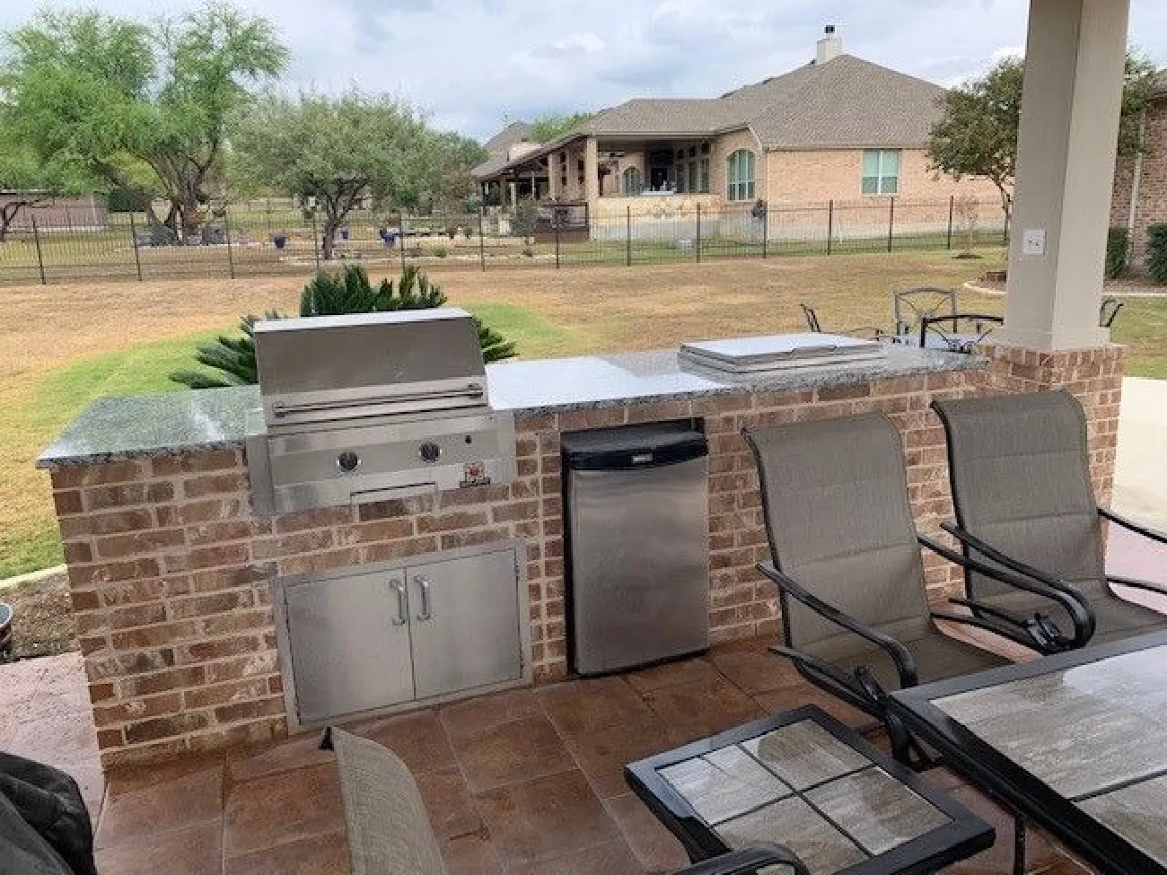 outdoor kitchen with stainless steel appliances and furniture