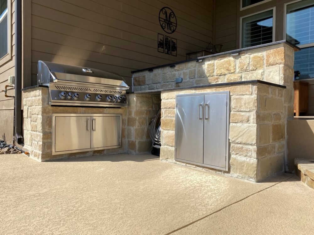 outdoor kitchen with a stainless steel grill