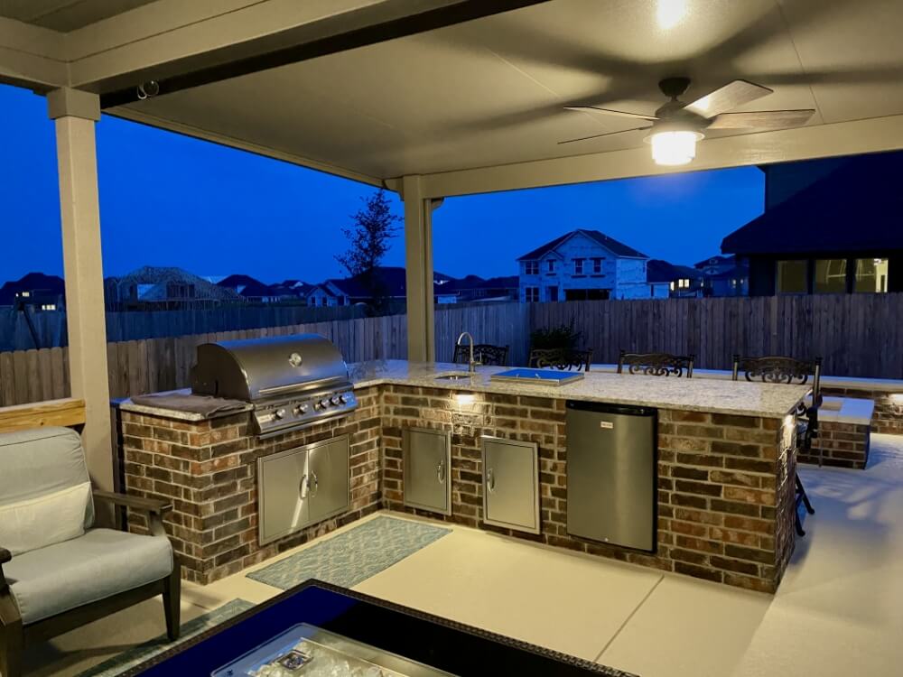 outdoor kitchen under a large patio cover