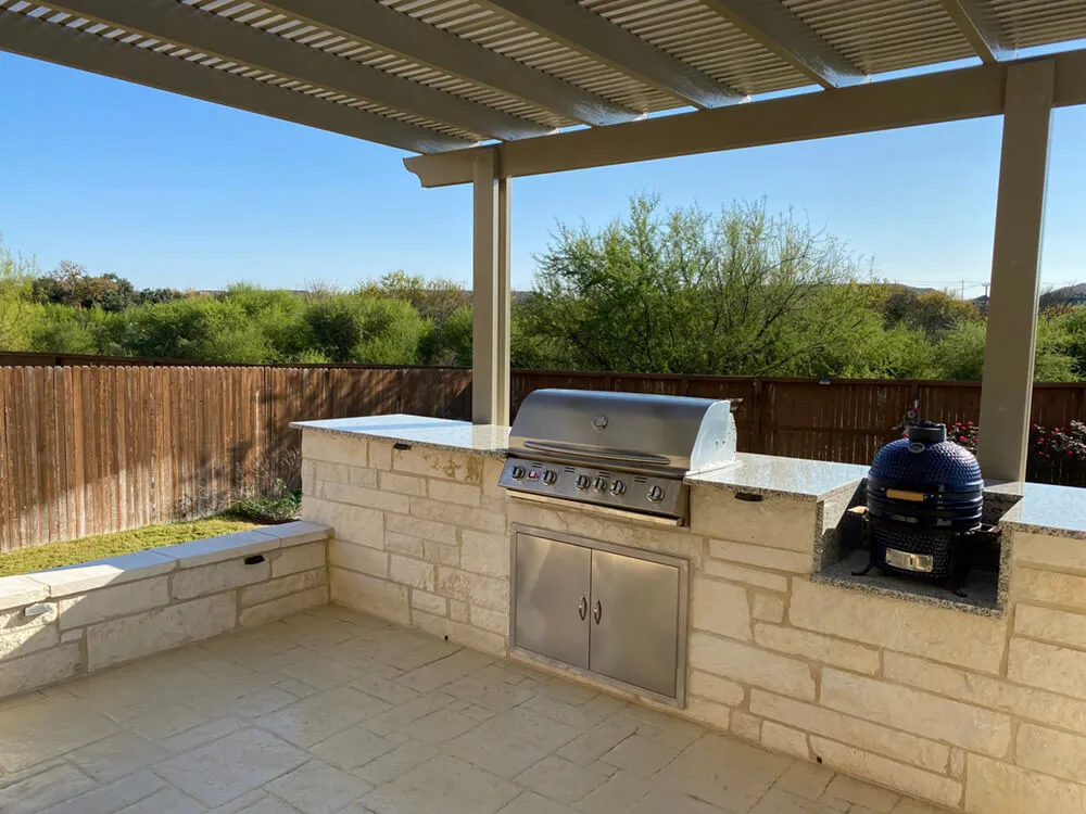 outdoor kitchen below a green awning