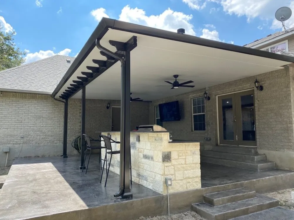 Covered patio with bar, chairs, stone finish.