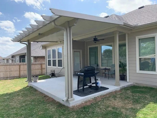 Covered patio with pergola in backyard.