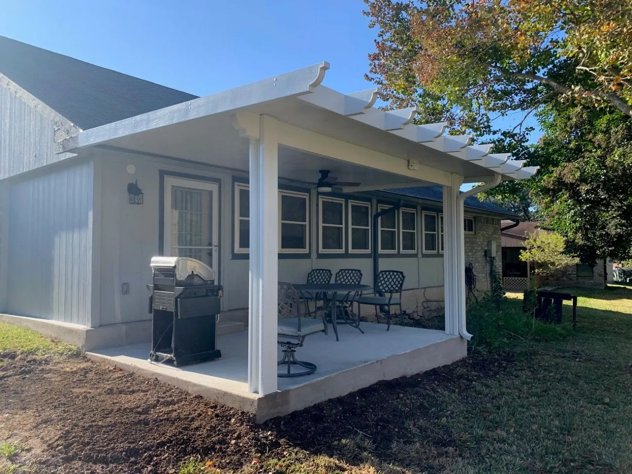 whtie patio cover with terrace style roof