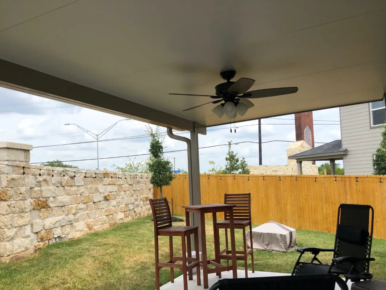 Patio cover with fan and simple furniture