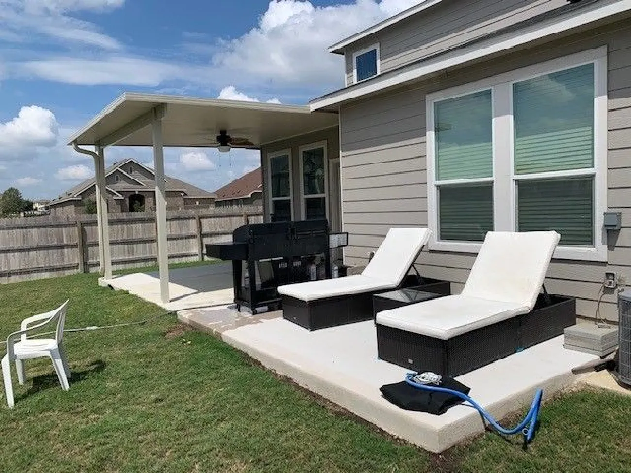 patio cover with custom white concrete deck and recliner chairs