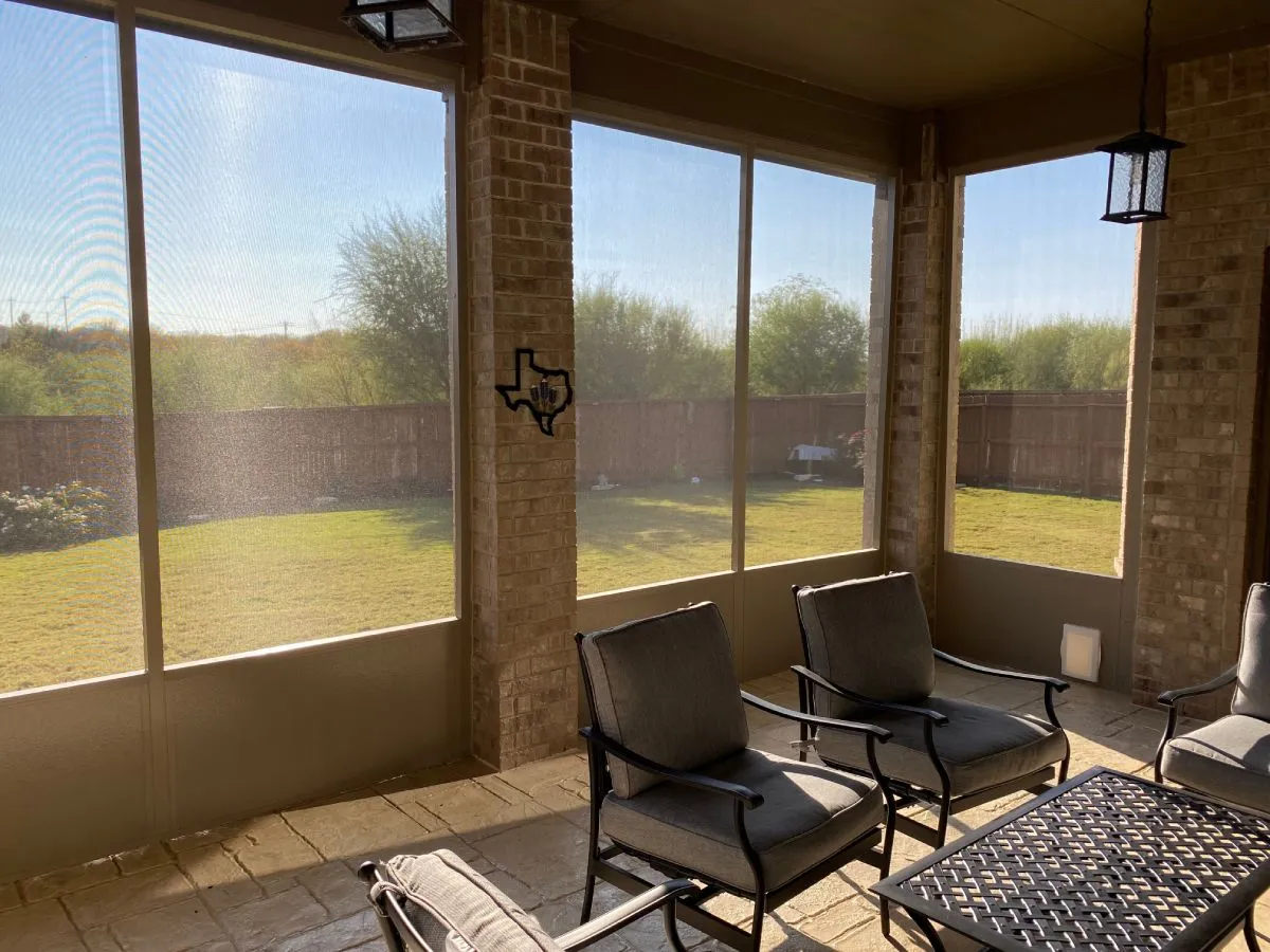 Screened patio with chairs, San Antonio home.