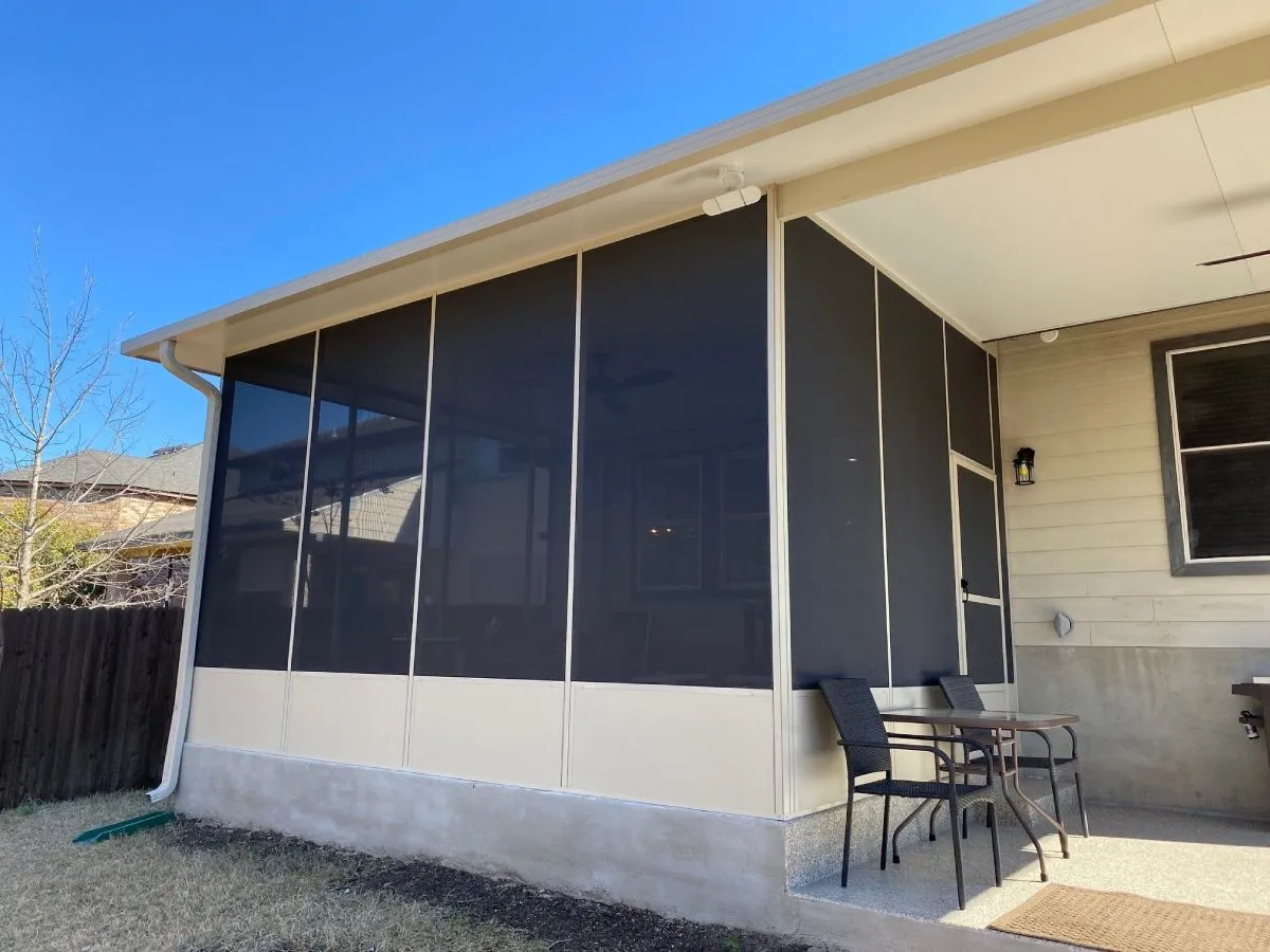 Covered patio with screen enclosure and outdoor furniture.