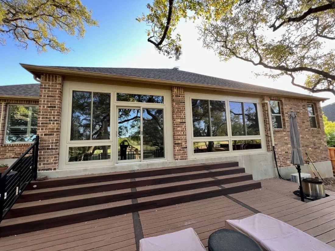 exterior view of a beige patio enclosure with large windows on a one story home in san antonio