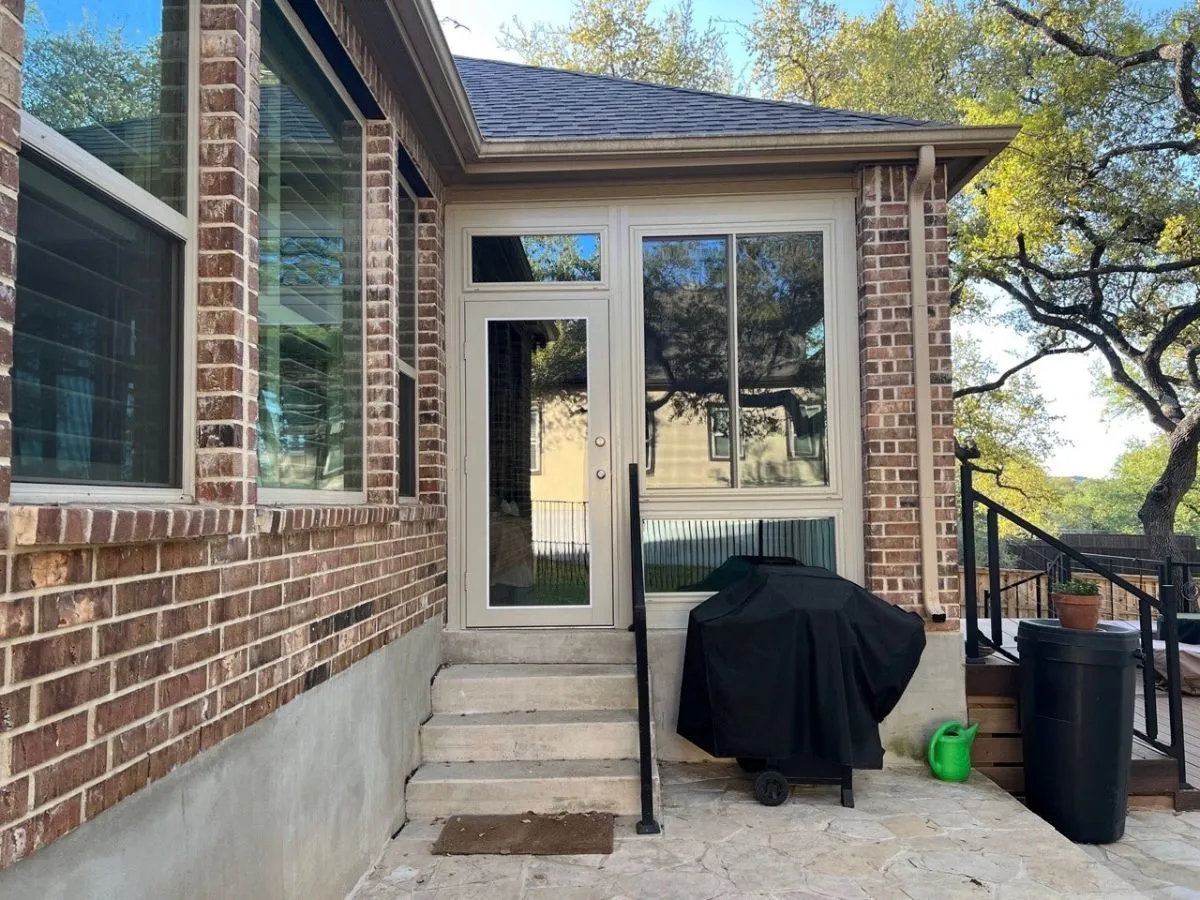 Sunny patio with glass door and grill, San Antonio.
