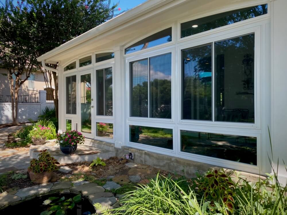 Patio enclosure with large glass windows.