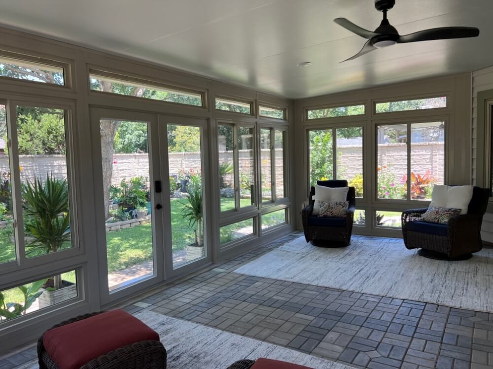 Sunroom with large windows and patio view.