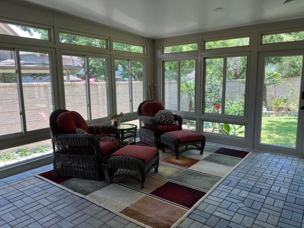 patio enclosure with red chairs inside