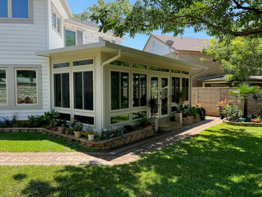 Patio enclosure in sunny backyard.