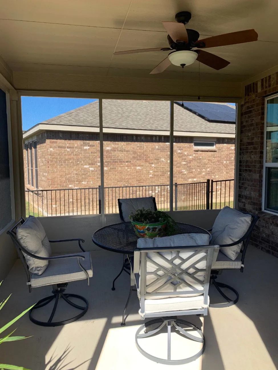 patio enclosure with patio furniture and a fan