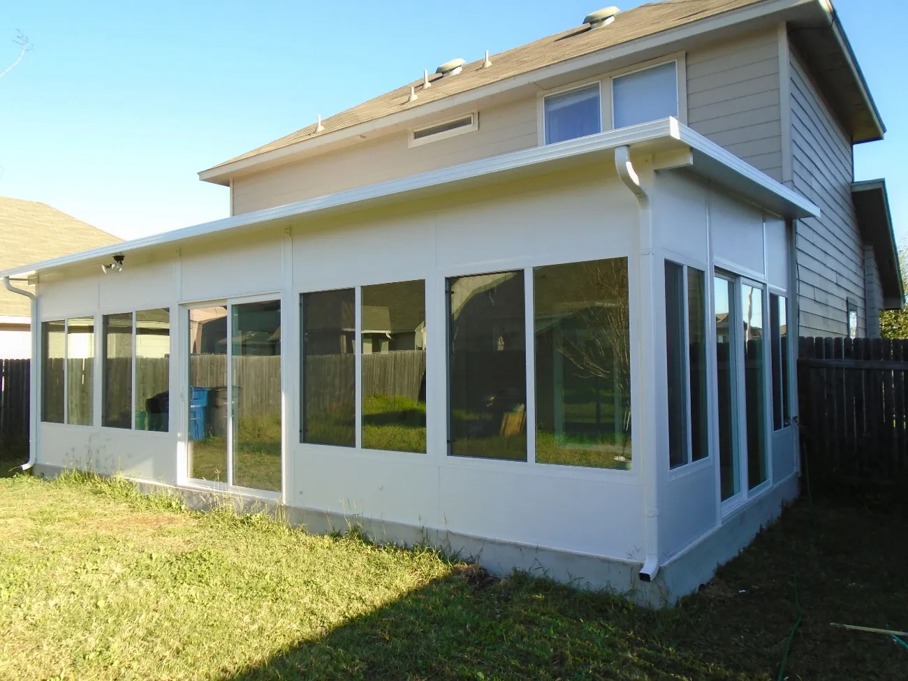 patio enclosure with white complimentary siding