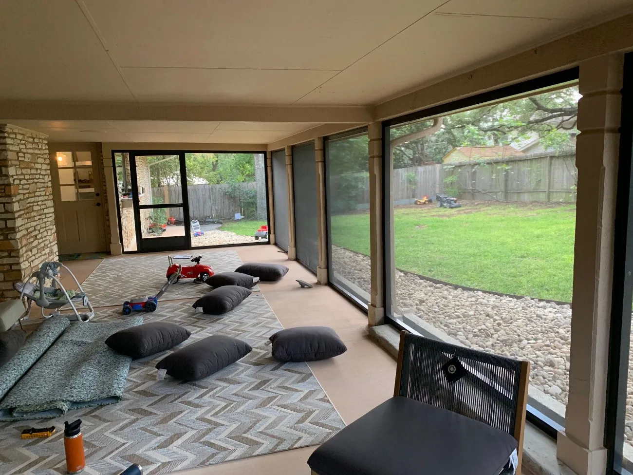 screened in patio that's been converted into a children's play room