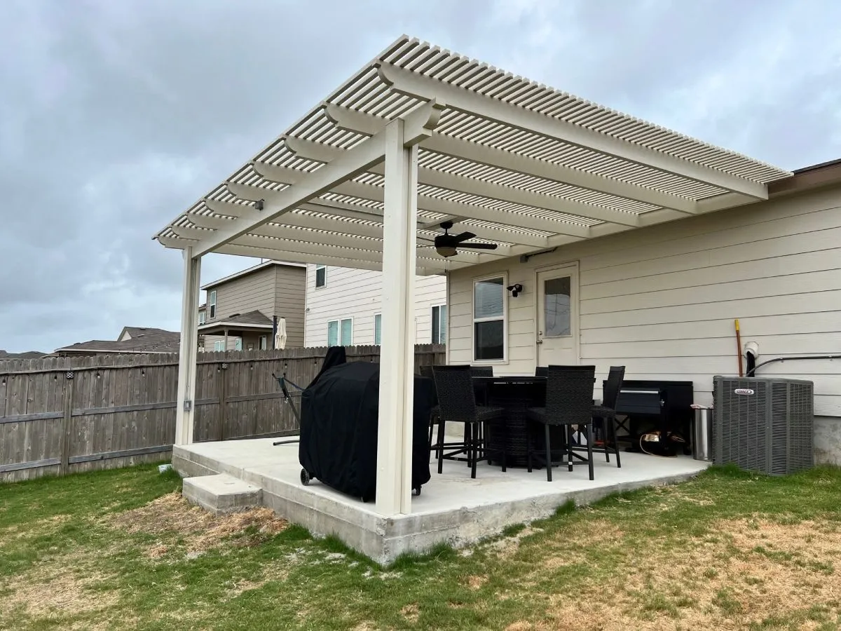 Backyard pergola with patio furniture in San Antonio home.