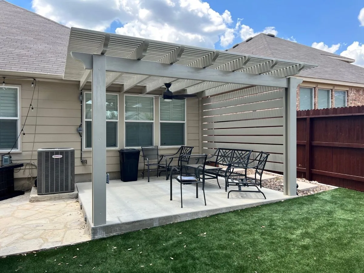 Backyard pergola with patio furniture.