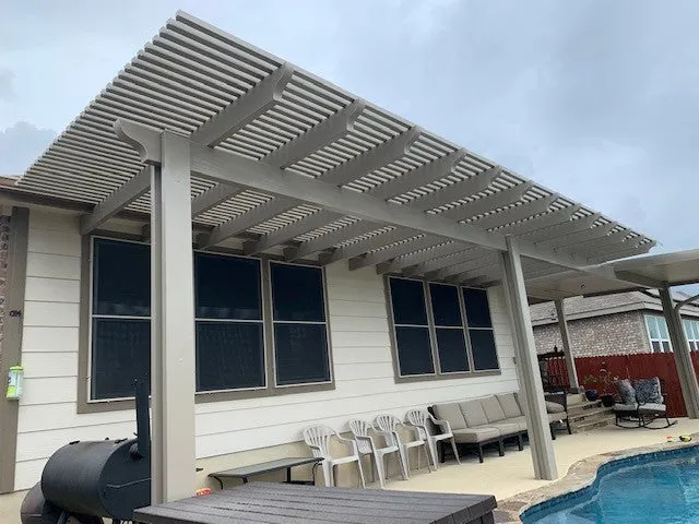 Pergola over patio with grill and seating, San Antonio home.