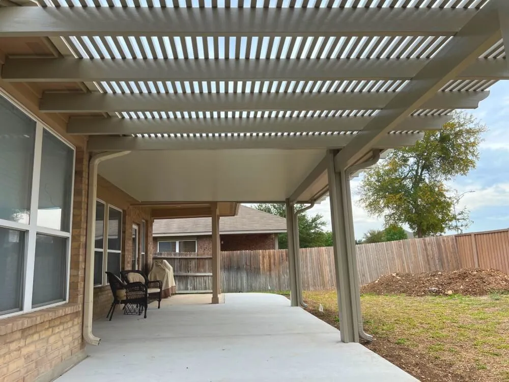 Pergola-covered patio with chairs, San Antonio backyard.