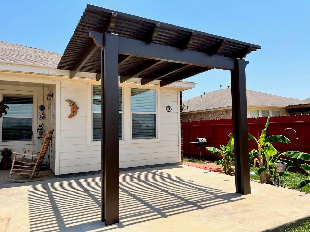Modern pergola on sunny patio in San Antonio backyard.