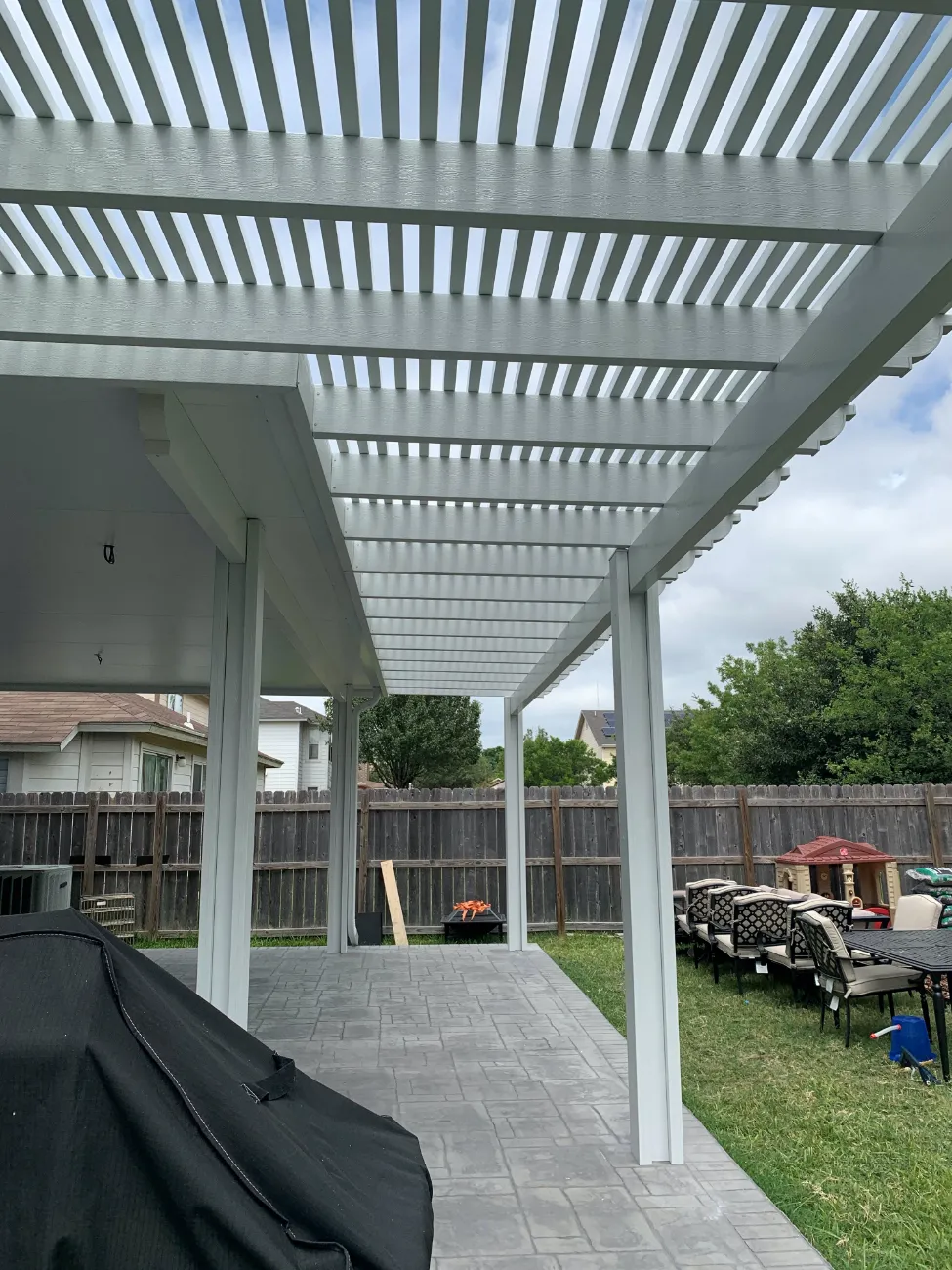white pergola in wooden slabs and concrete foundation