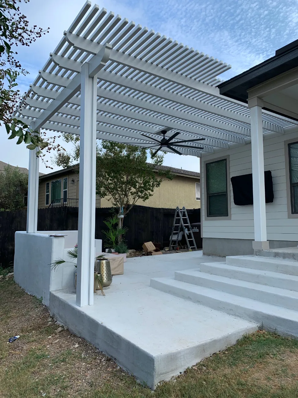 white patio cover with white concrete patio