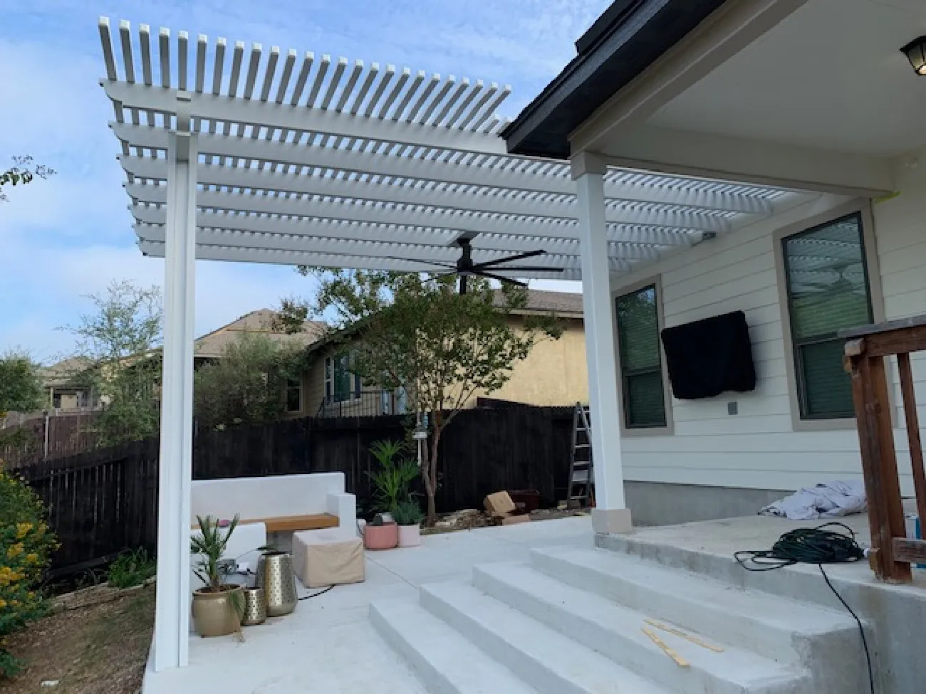 white pergola in white steps and patio