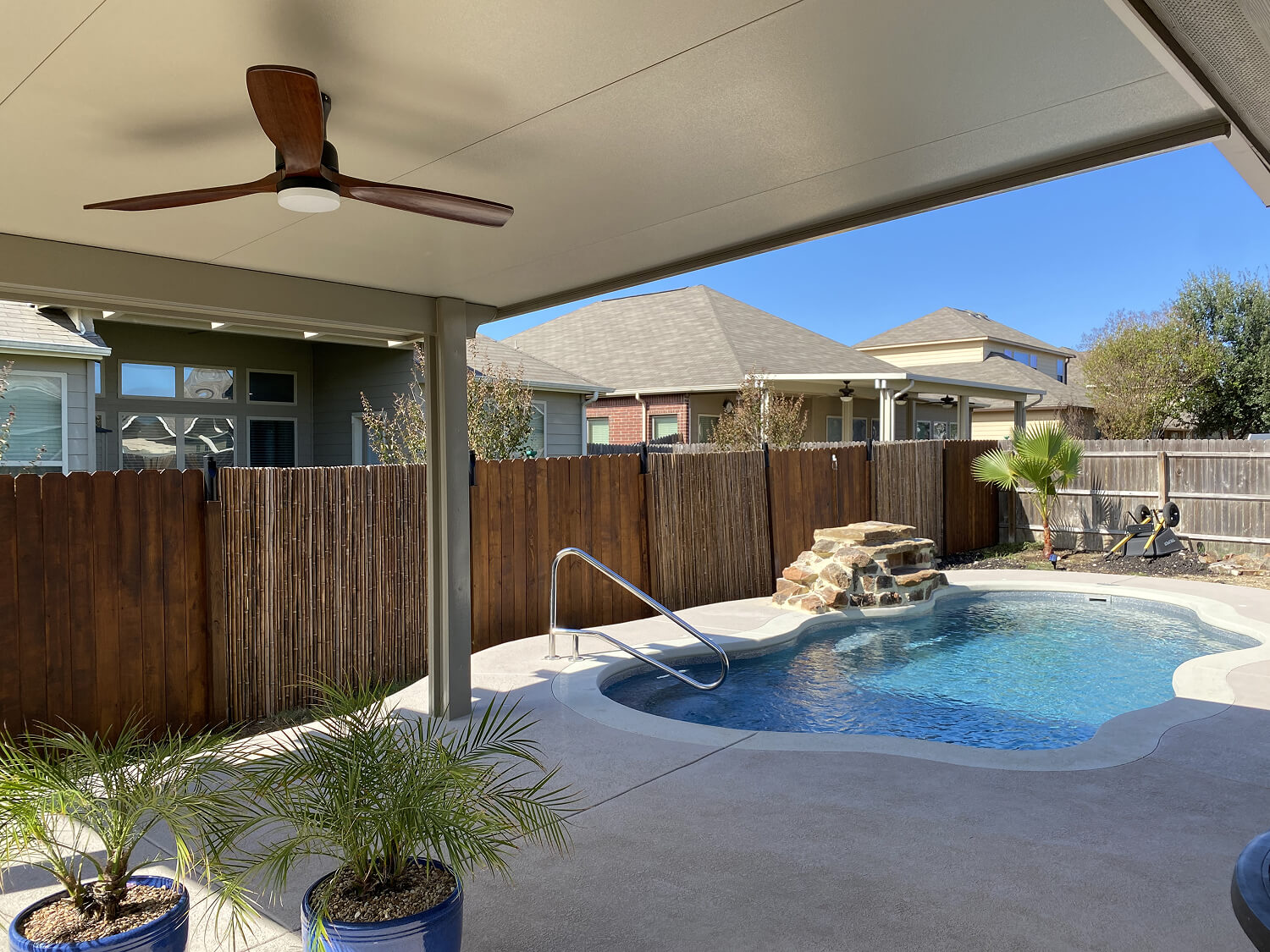 Covered patio view of backyard pool in San Antonio.