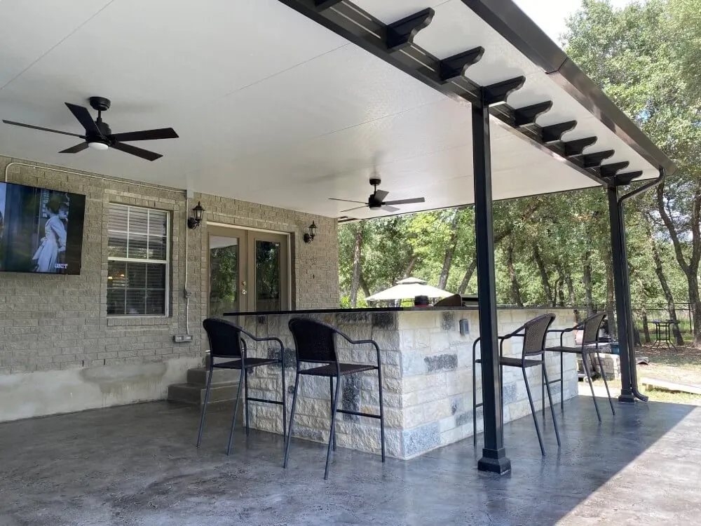 Modern patio with bar, ceiling fans, and TV.