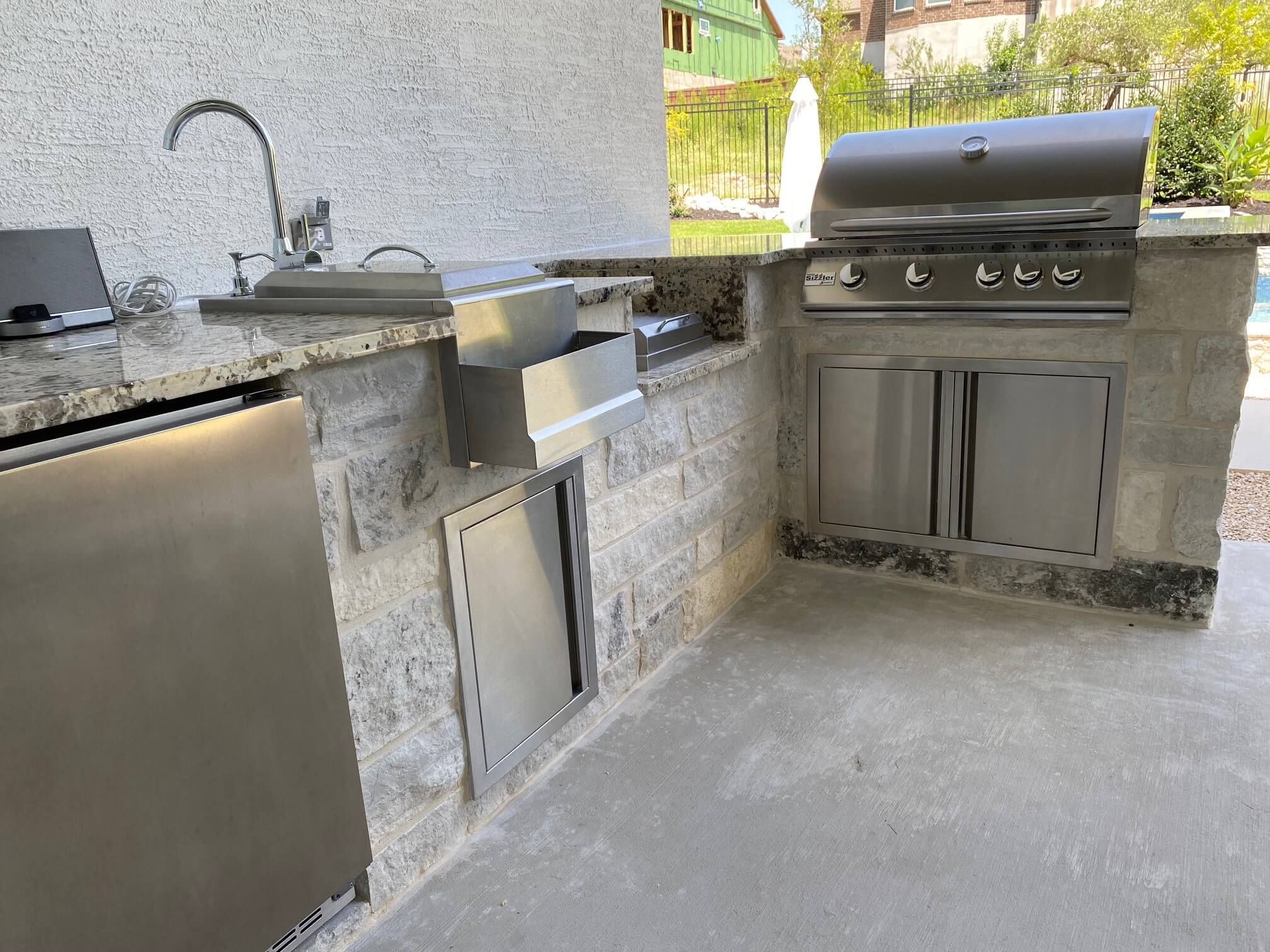 outdoor kitchen with matching stainless steel appliances