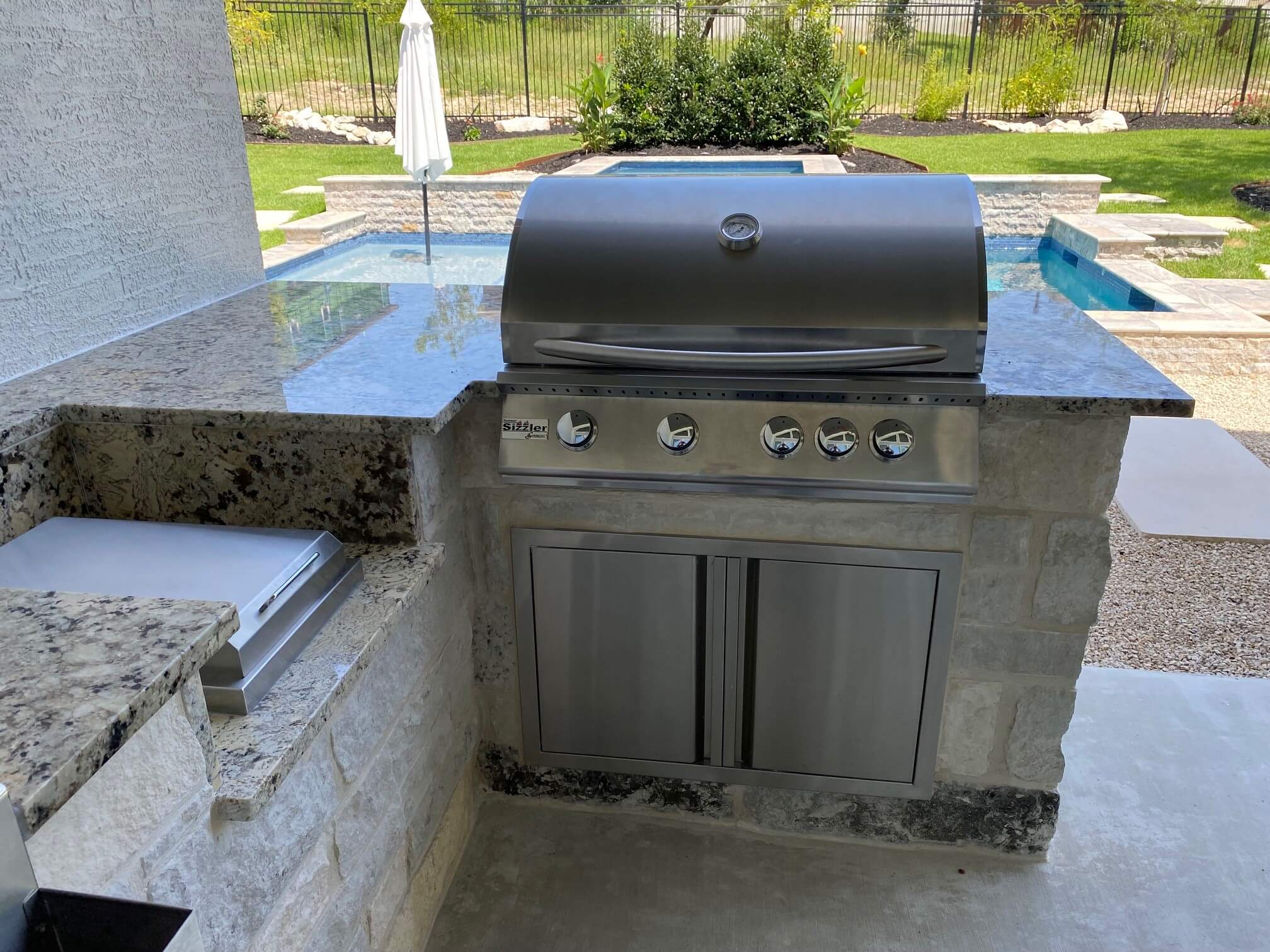 large stainless steel outdoor grill with marble
