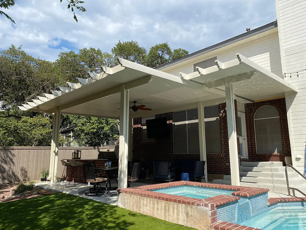 Large pergola over patio and outdoor kitchen in backyard, San Antonio.