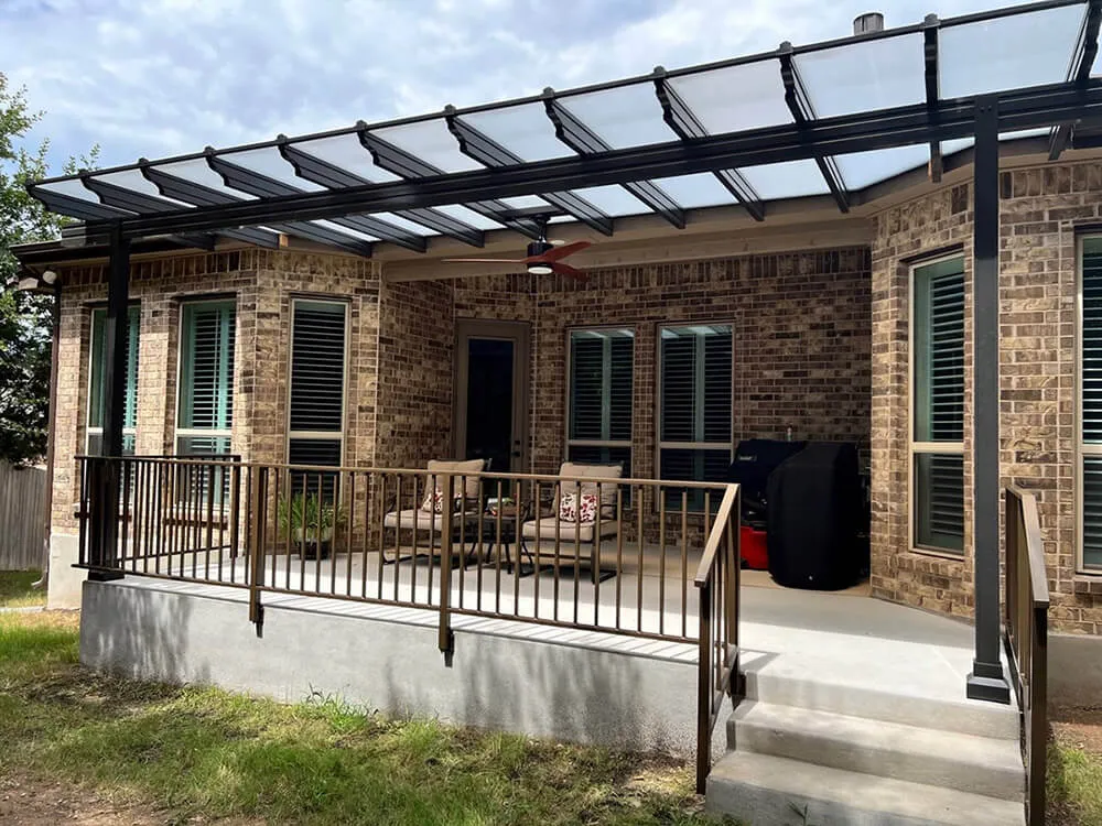 Backyard patio with pergola and seating area.