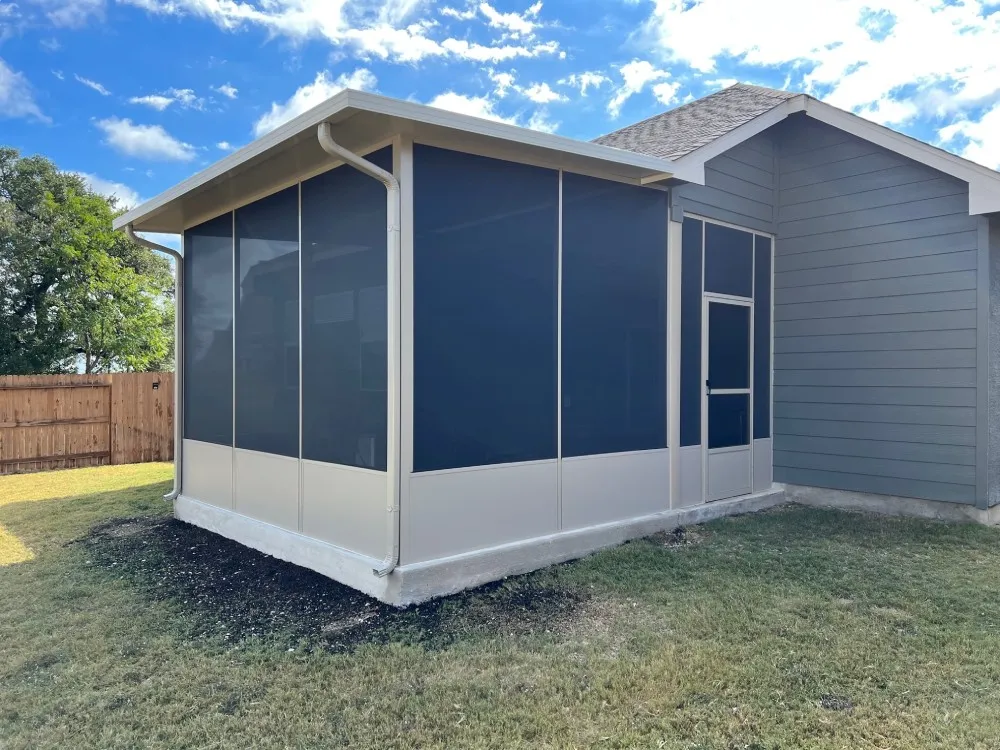 Screened patio enclosure on gray house