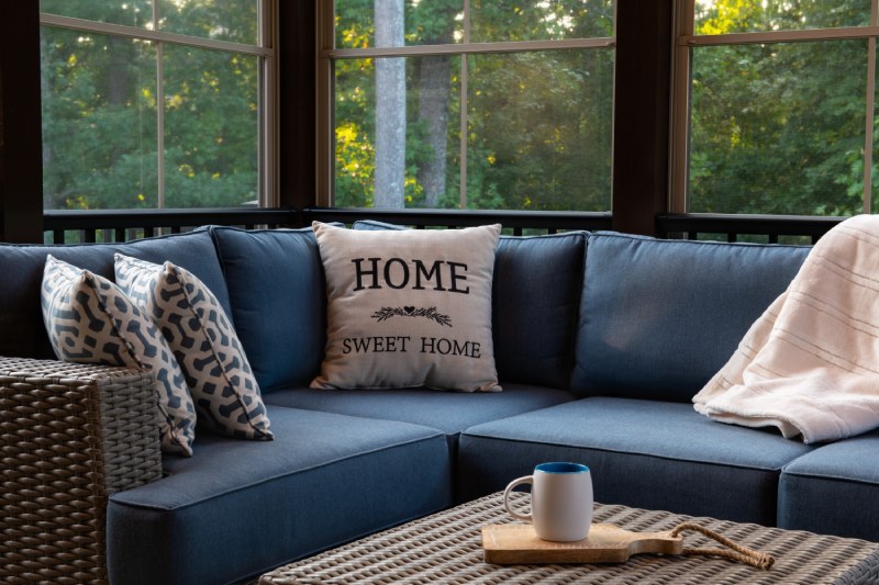 Cozy patio seating area with "Home Sweet Home" pillow.
