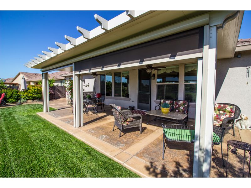 White patio cover with furniture beneath
