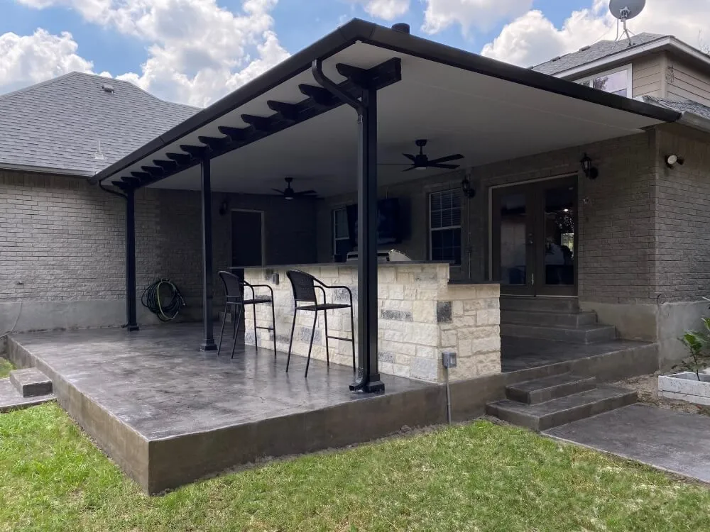 Black patio cover in San Antonio with outdoor seating.