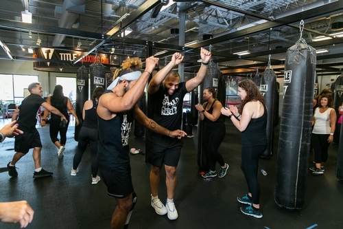 A fitness class warming up together