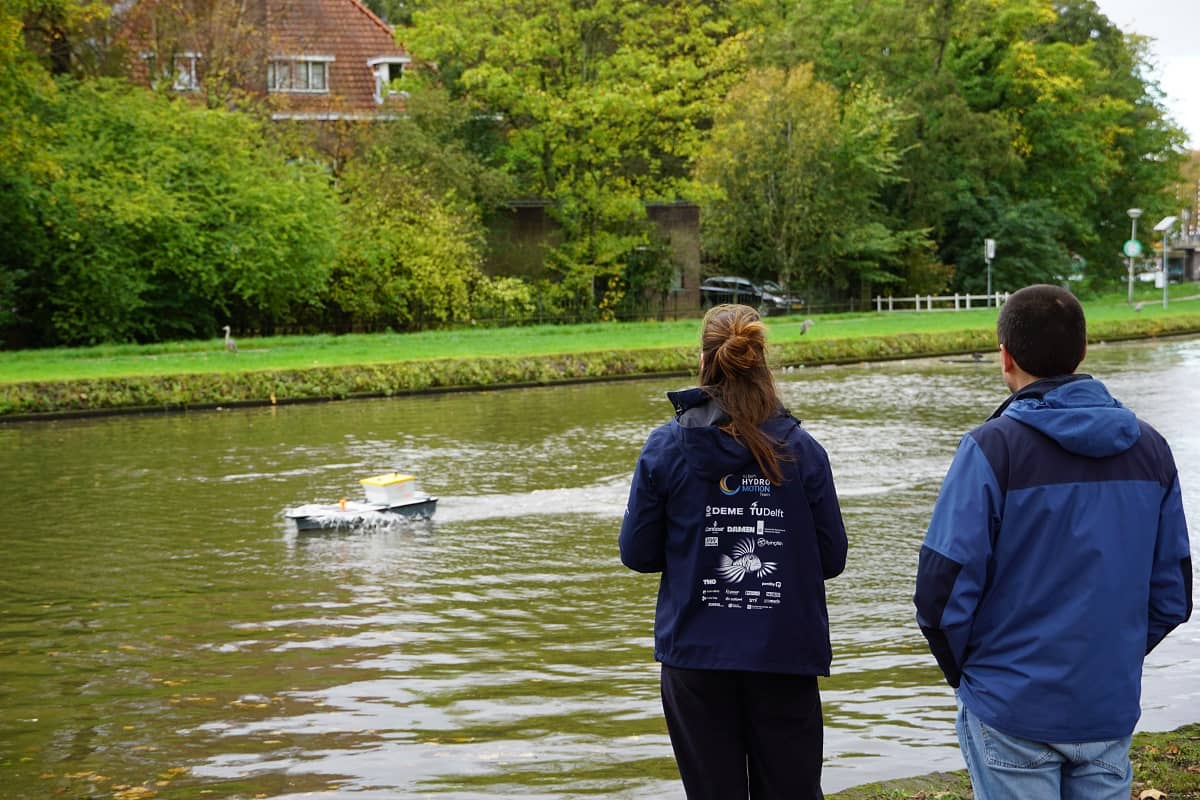Photo of two Flying Fish engineers, testing the Flying Fish 1 hydrofoil demonstrator boat in Delft.