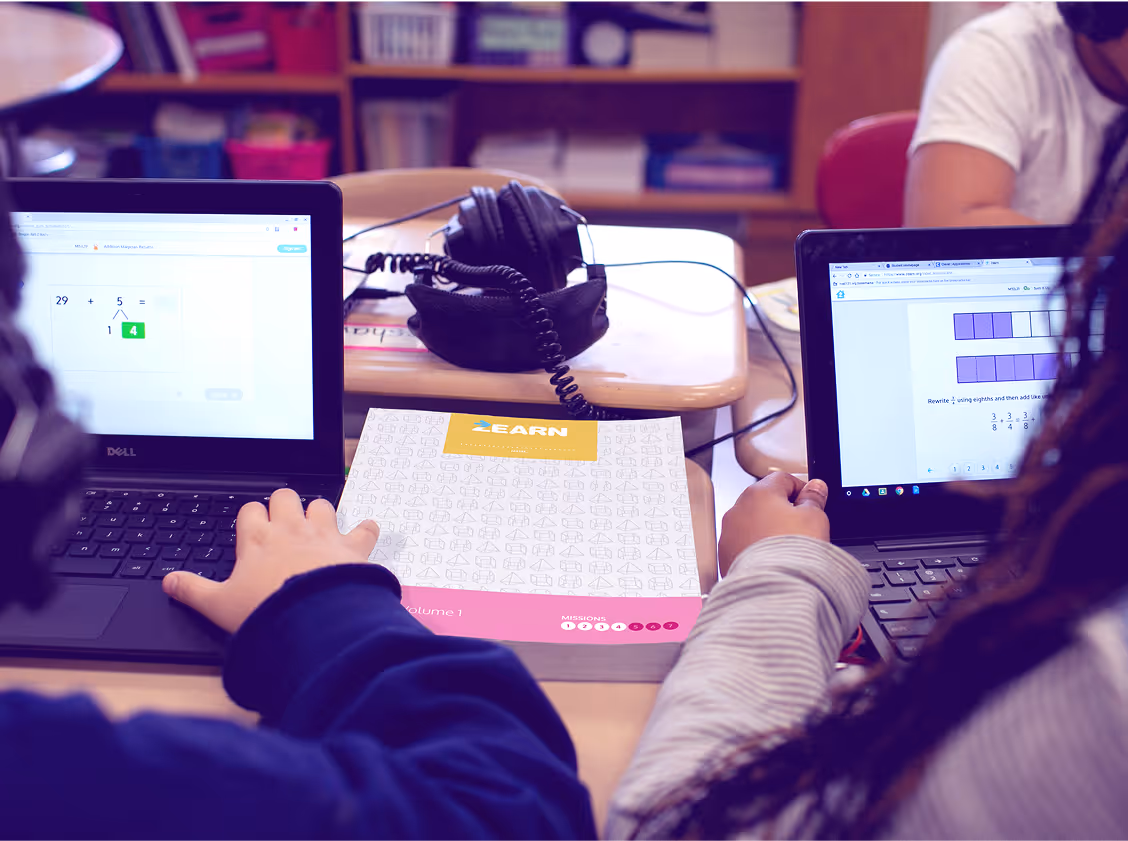 Students completing Zearn online lessons and printed materials in the classroom