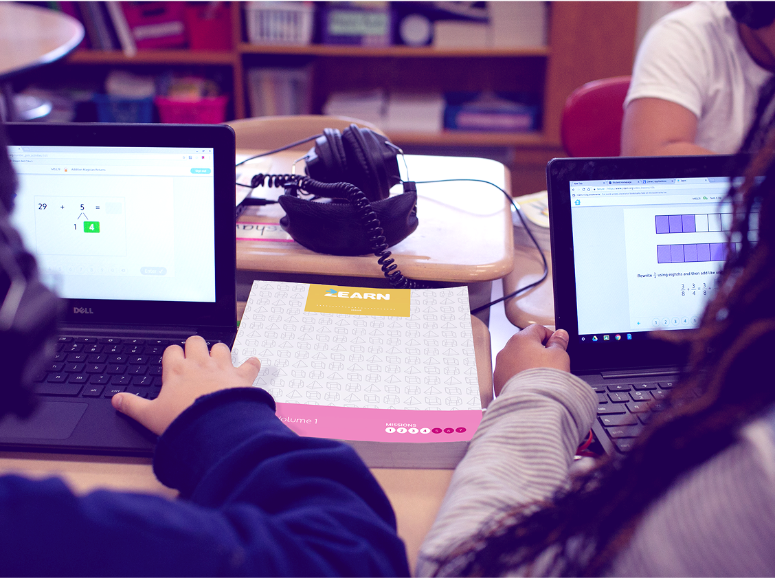 Students completing Zearn online lessons and printed materials in the classroom