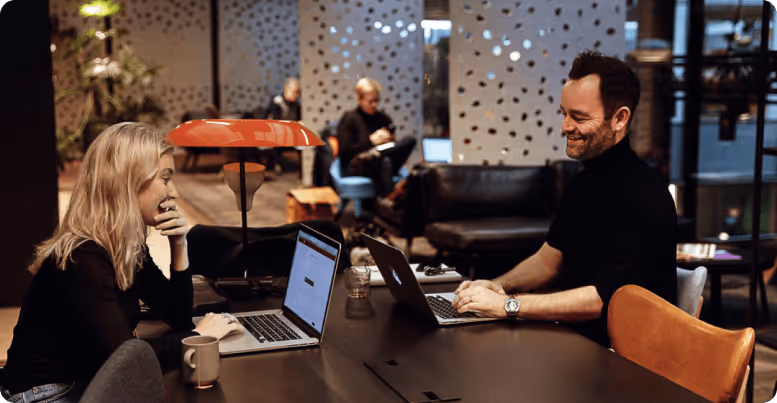 Two people working in shared workspace