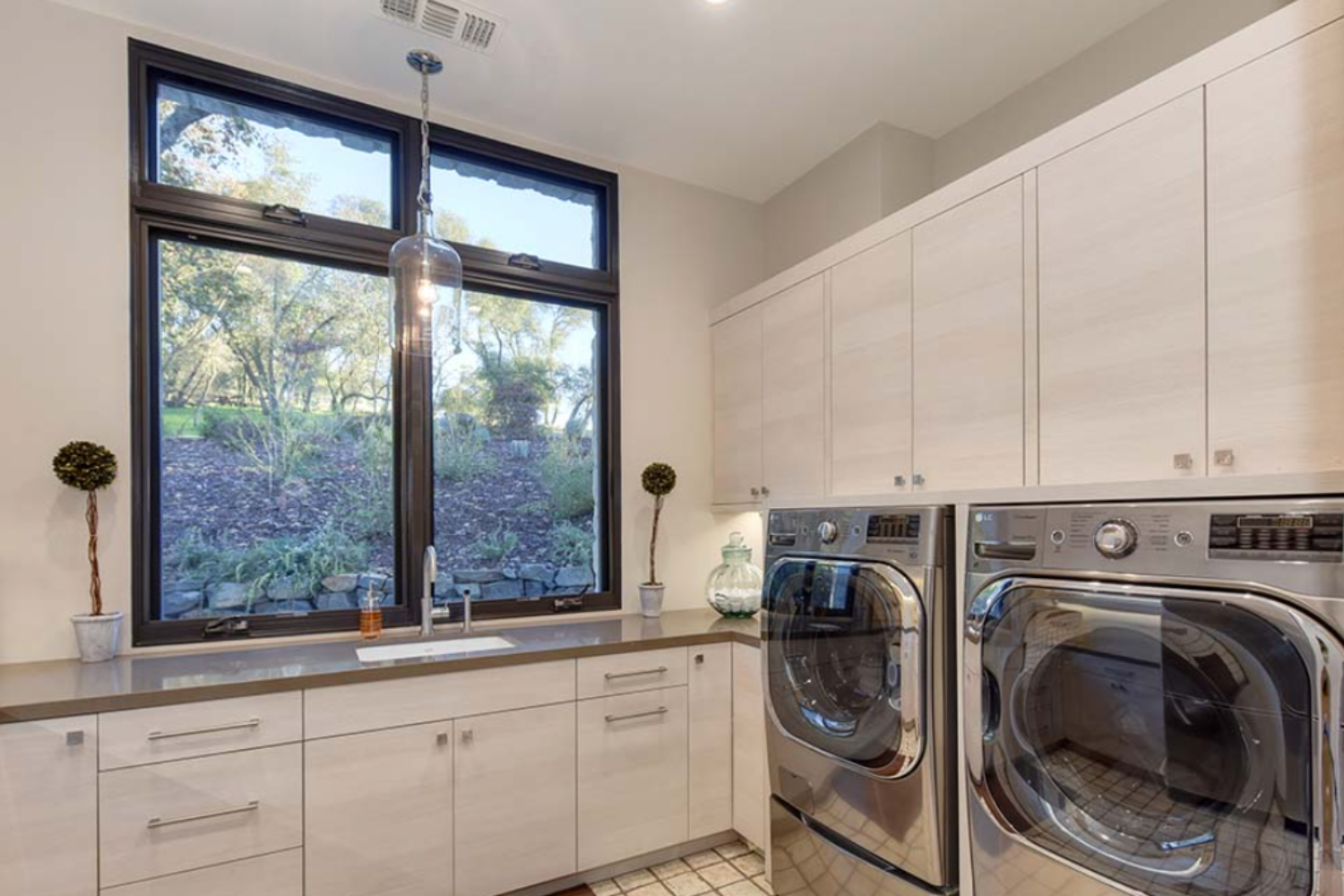 Modern laundry room with window view.