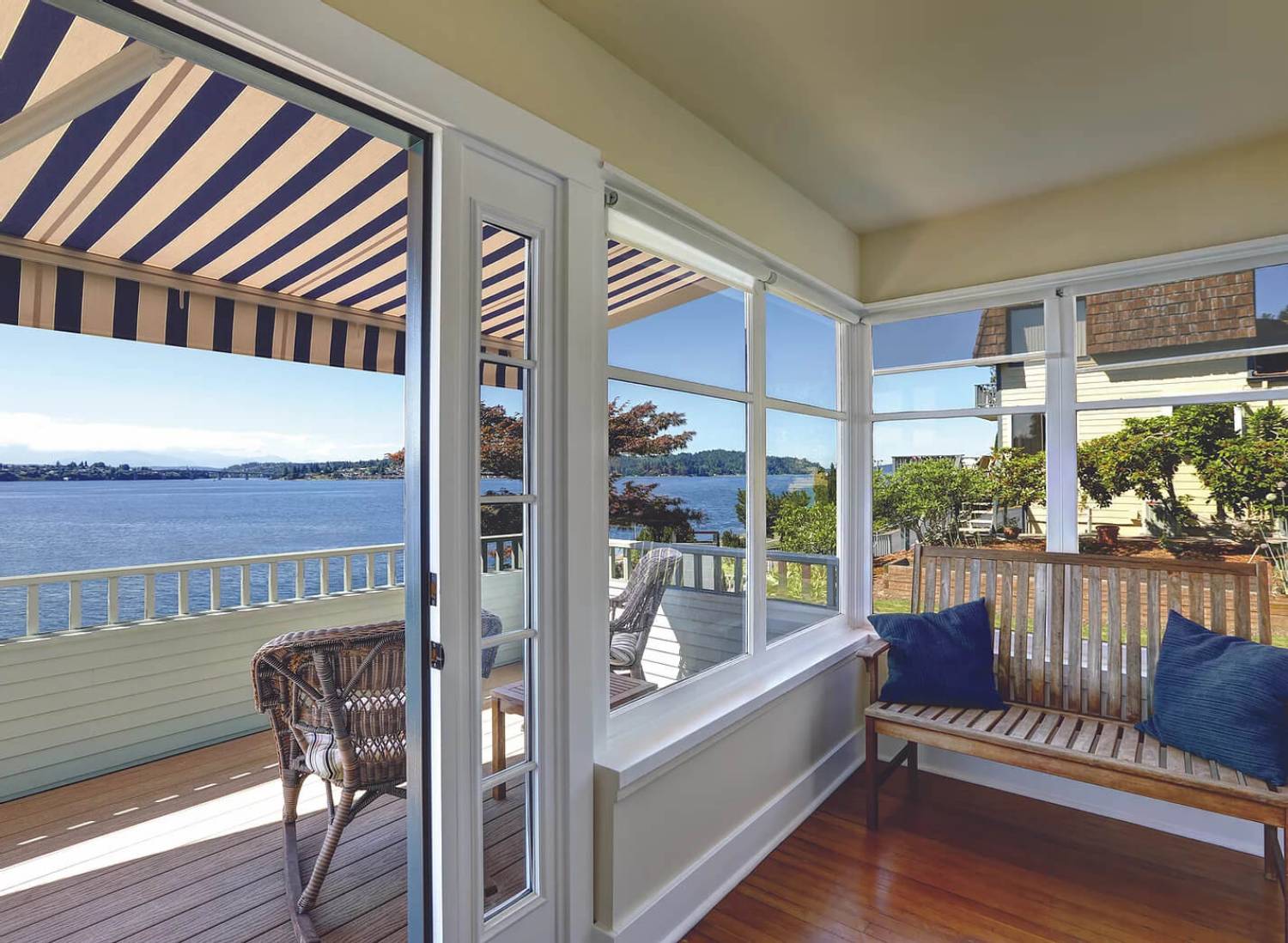 Covered porch with view of lake and trees.
