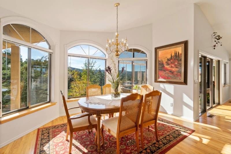 Dining room with large windows and round table.