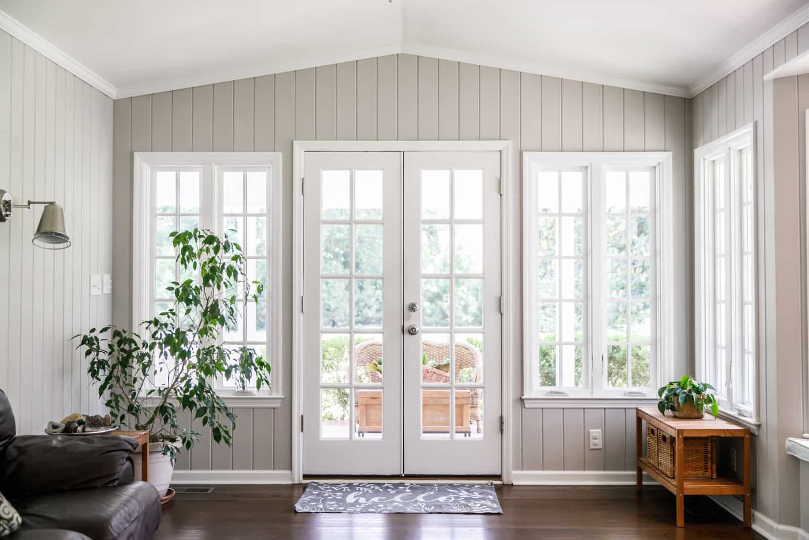 Bright living room with French doors and plants.
