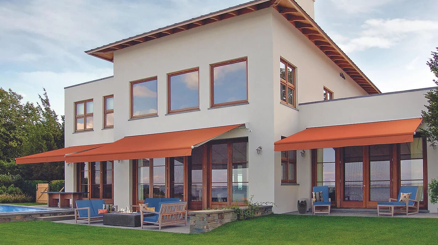 Modern house with orange awnings.