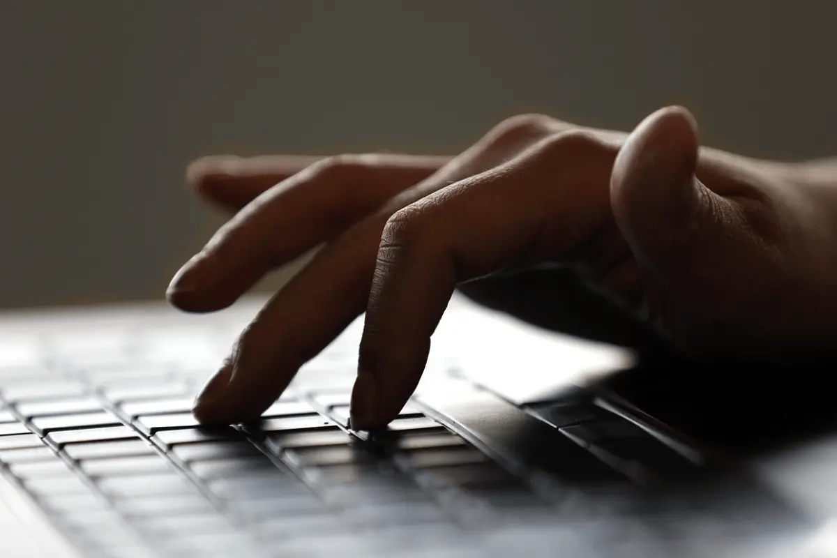 Close-up of hands typing on a keyboard.